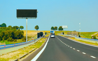 Canvas Print - Scenery with car at road Poland reflex