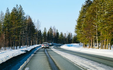 Canvas Print - Car on a road at snowy winter Lapland reflex