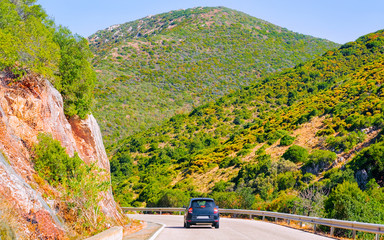 Canvas Print - Scenery with car in highway in Cagliari in Sardinia hills reflex