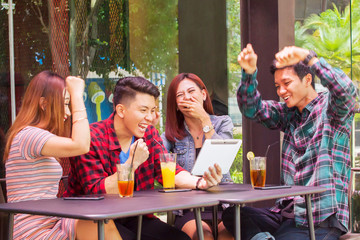 Cheerful young people looking at digital tablet