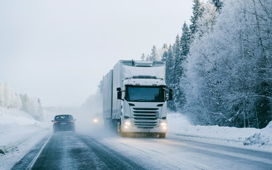 Wall Mural - Truck at the Snowy winter Road Finland Lapland reflex