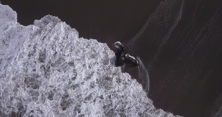 Wall Mural - Aerial view of waves crashing over rocks at the Batu Bolong beach, Bali, Indonesia 