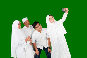 Wall Mural - Happy muslim family taking selfie photo together