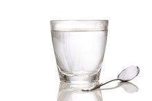 ORS Or Oral Rehydration Salt With Glass Of Water And Spoon