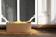 © Natalie Jeffcott - A box of fresh fruit and vegetables is left at a front door