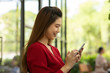 © 220 Selfmade studio - Beautiful Young Asian Woman smile and using Smartphone to connecting social media or Shopping online from App in device at coffee shop cafe enjoy and happiness,Woman with Smartphone Concept