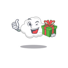 Wall Mural - Smiling white cloud cartoon character having a green gift box