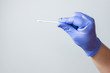 © FranciscoJavier - blue gloved hand holding coronavirus nasal test stick, or covid-19. Coronavirus test concept.