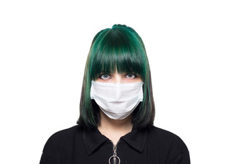 Beautiful young girl in a medical mask with green hair on a white background