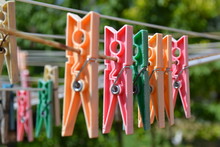 Close-up Of Multi Colored Clothespins Hanging On Wire