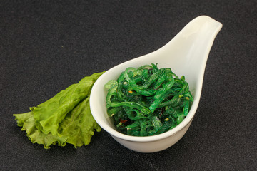 Green Chuka Seaweed Salad Isolated on White Background Top View. Wakame Sea Kelp Salat