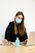 © Роман Котиков - Coronavirus. Young business woman working from home wearing protective mask. Business woman in quarantine