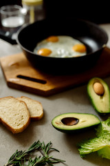 Wall Mural - Healthy breakfast: scrambled eggs, toast, avocado, lettuce, rosemary
