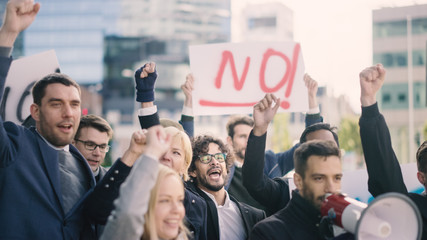 Wall Mural - Multicultural Diverse Office Managers and Business People Picketing Outside on a Street. Men and Women Screaming for Justice, Holding a Megaphone, Picket Signs and Posters. Economic Crisis Strike.