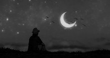 A Girl Sit On A Grass Looking At Beautiful Moon.black And White