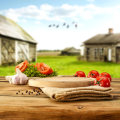 Poster - Desk with vegetables and rural landscape 