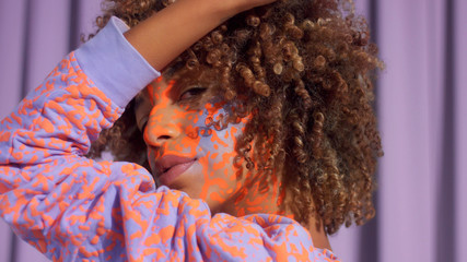 Wall Mural - Closeup portrait of mixed race woman with neon makeup . new beauty concept, authentic identity Studio photo