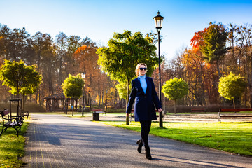 Wall Mural - middle-aged woman walking in city park
