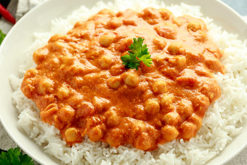 Spicy chickpeas curry with rice, tomato and Poppadoms in white plate. Healthy tasty vegetarian food