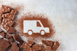 © Gulsina - Car made of cocoa powder and chocolate on a light background. Online shopping. Concept of delivery services, logistics, cargo delivery.