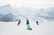 © guruXOX - Group of freeride snowboarders rolls and rides snowboards on slope