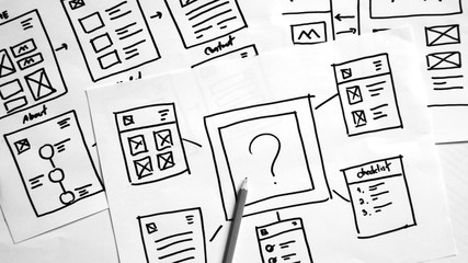 Wall Mural - user experience design, desk with paper sketches for mobile interface.