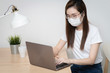 © dieprince - Asian woman is working from home during coronavirus or COVID-19  with laptops and computers at home,   wearing protective mask, quarantine for coronavirus