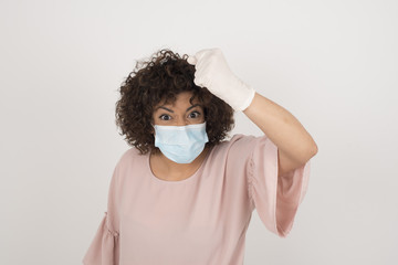 Sticker - Fierce confident European dark-haired woman holding fist in front of her as if is ready for fight or challenge, screaming and having aggressive expression on face wearing medical mask