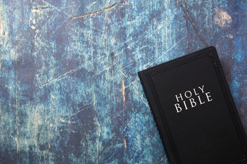 Wall Mural - A Holy Bible Closed on a Blue Wooden Table with Copy Space