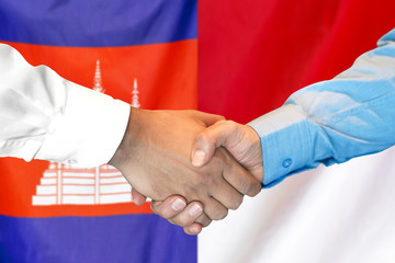 Handshake on Cambodia and Monaco flag background. Support concept.