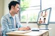 © Kawee - Asian business man talking to colleague team about plan in video conference. Group of business people using computer for remote online meeting in video call conference. Smart working from home.