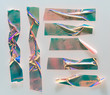 Shiny crumpled stickers with real shadow. Nice set of metallic holographic sticky tape shapes isolated on white plastic background. Holo glitter stripes or snips for your design poster.