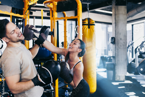 Young attractive woman with instructor on kickboxing training Фотошпалери