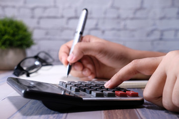 Sticker - women hand using calculator on offie desk.