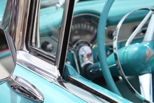 SIDE OF A VINTAGE CAR, COLLECTORS, BLUE, CLASSIC, ANTIQUE, STEERING WHEEL