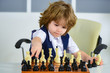 Businessman play with chess game. Concept of business strategy and tactic. A child as a small businessman with strategic thinking. Chess for children.
