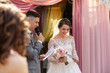 Marriage vow, the groom makes a promise to the bride during the wedding ceremony pink wedding arch