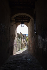 Wall Mural - Street view through an arch in Arrezzo, Tuscany, Italy.