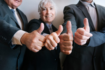 Wall Mural - Senior business people giving thumbs up