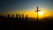 Christians praying for patients with coronavirus against sunset and cross