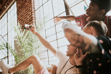 Wall Mural - Happy friends taking a selfie