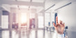 © adam121 - Choosing gesture of businessperson in elegant modern interior in sunshine light