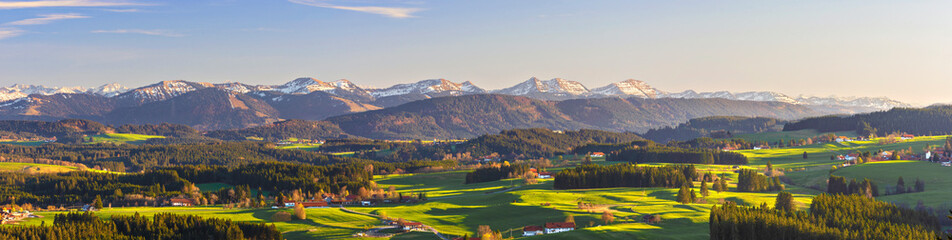 Wall Mural - Panorama of Allgäu landscape with mountains, meadows and forest in spring. Bavaria, Germany