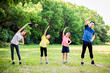 © Tom Wang - happy family exercising  together at the park