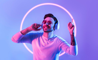 Canvas Print - Guy dances to favorite music in neon circle