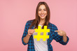 Attention to interesting blog post. Happy girl in shirt pointing at yellow hashtag symbol, making important topic popular, setting trends on Internet. indoor studio shot isolated on pink background