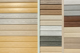 Fototapeta Na ścianę - Vinyl siding with imitation wood texture in bright palette of colors. Plastic wall covering for exterior decoration of house. Abstract background for your design with copy space and place for text