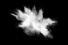 Freeze Motion Of White Color Powder Exploding On Dark Background. 