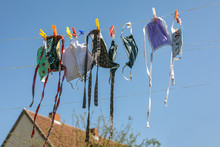 Washed makeshift fabric face masks are drying on a clothes line