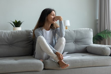 Depressed Young Woman Suffering From Break Up With Boyfriend Or Divorce With Husband, Holding Torn Photo, Bad Relationship, Stressed Upset Girl Crying, Feeling Lonely, Sitting On Couch At Home Alone